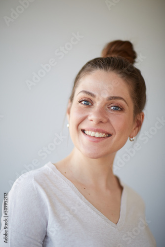 Smiling woman close up face portrait. Female head shot with shallow depth of field.