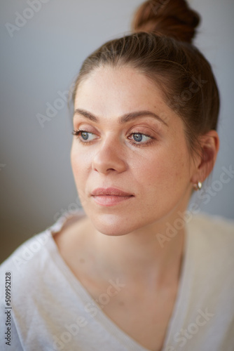 Focused thinking woman face portrait. Girl looking away. Female head shot with shallow depth of field.
