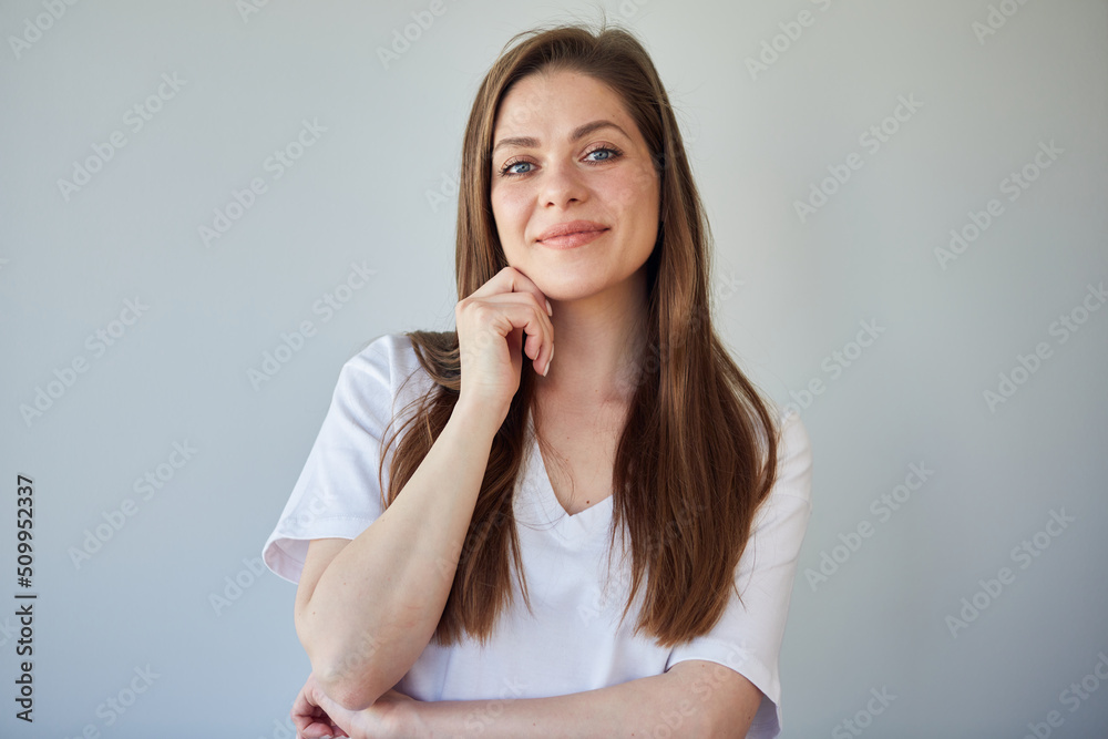 Smiling woman in white shirt touching her face. isolated portrait. Smiling woman in white shirt touching her face. isolated portrait.