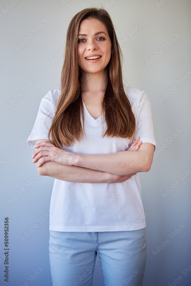 Smiling woman in white shirt portrait with crossed arms. Happy girl in white casual clothes. Smiling woman in white shirt portrait with crossed arms. Happy girl in white casual clothes.