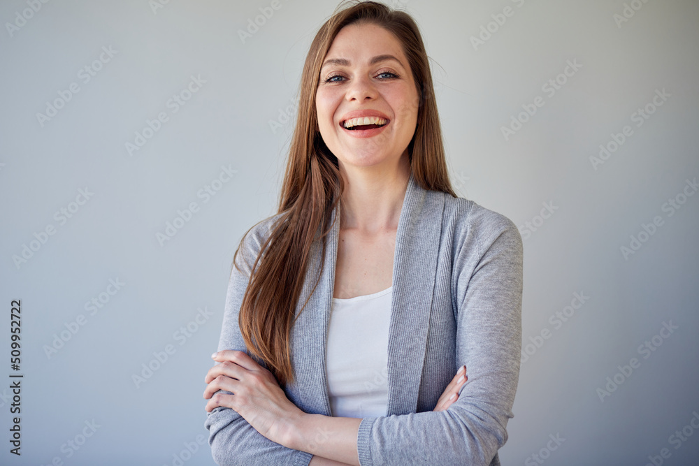 Smiling girl in casual gray clothes standing with crossed arms. Smiling girl in casual gray clothes standing with crossed arms.