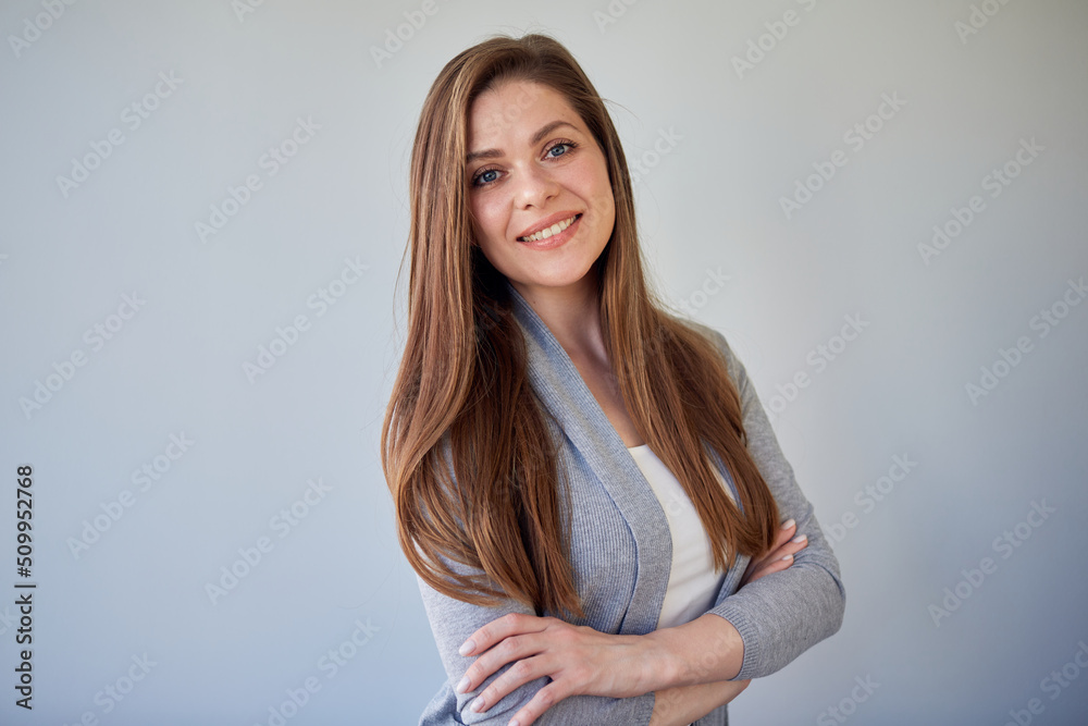 Beautiful smiling woman with natural skin and long hair. Isolated portrait of girl wearing casual clothes on gray background. Beautiful smiling woman with natural skin and long hair. Isolated portrait of girl wearing casual clothes on gray background.
