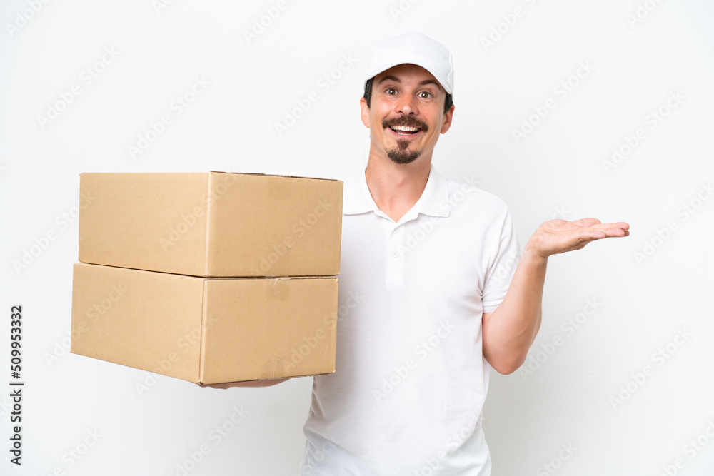 Delivery caucasian man isolated on white background with shocked facial expression Delivery caucasian man isolated on white background with shocked facial expression