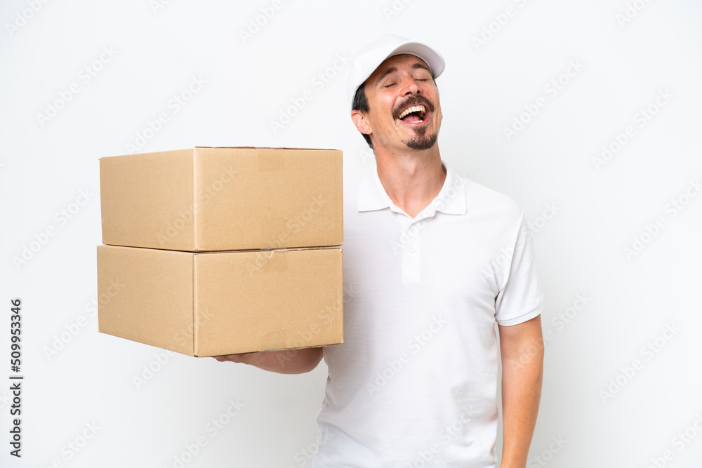 Delivery caucasian man isolated on white background laughing Delivery caucasian man isolated on white background laughing