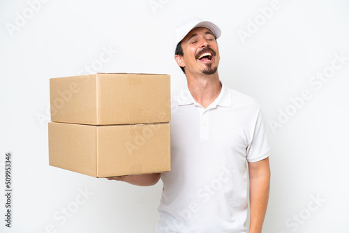 Delivery caucasian man isolated on white background laughing © luismolinero
