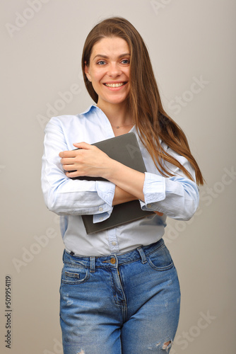 Casual dressed student girl holding book. Smiling woman with long hair portrait isolated.