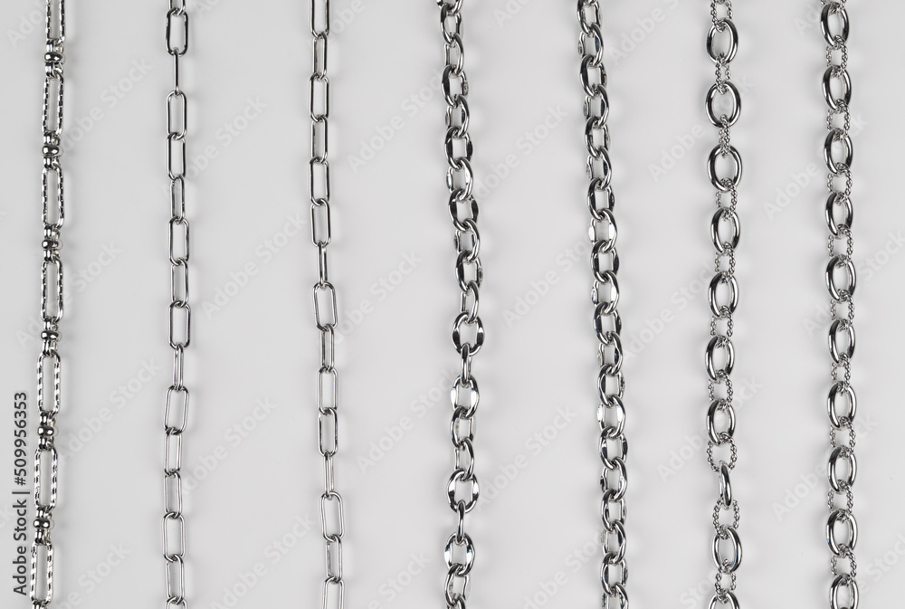 Set of different chains on white background. Chain connection, types of metal chains Set of different chains on white background. Chain connection, types of metal chains