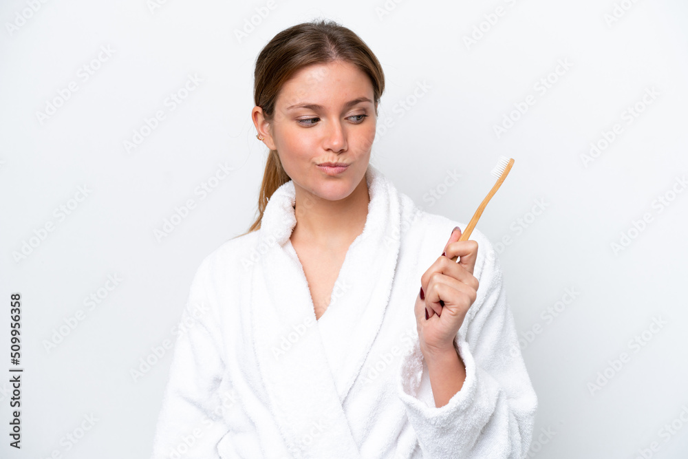 Young caucasian woman brushing teeth isolated on white background with sad expression Young caucasian woman brushing teeth isolated on white background with sad expression