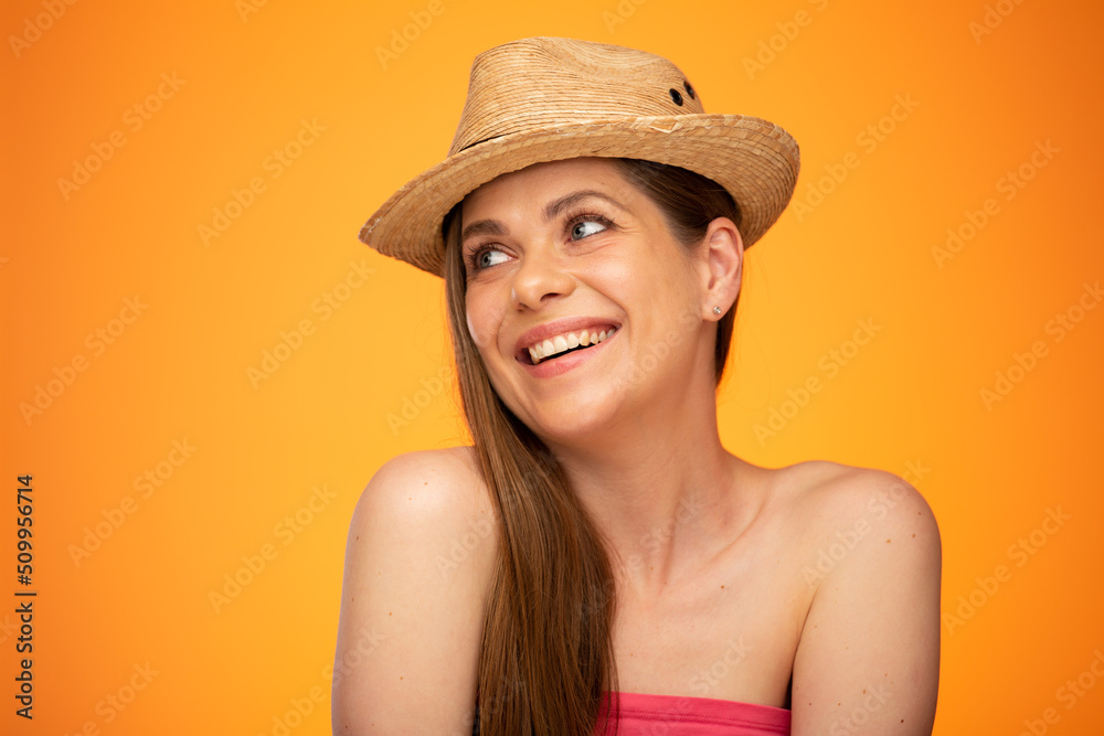 Smiling woman in straw hat looking up, face girl portrait isolated over orange yellow background. Smiling woman in straw hat looking up, face girl portrait isolated over orange yellow background.