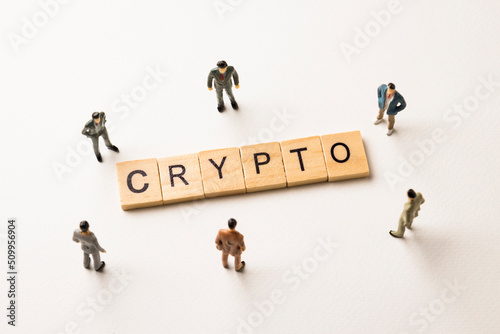 businessman figures at crypto words