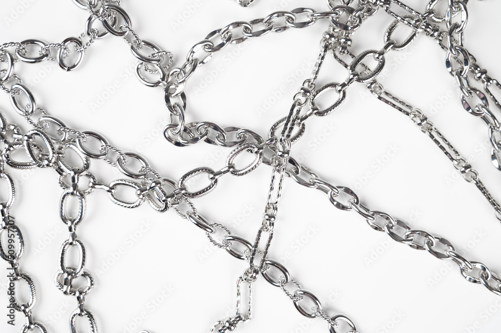 Metal chains isolated on white background top view. The concept of strength and power Metal chains isolated on white background top view. The concept of strength and power