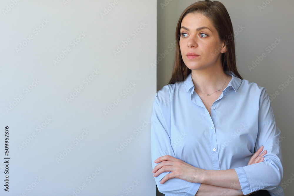 Serious business woman standing with crossed arms and looking away. Serious business woman standing with crossed arms and looking away.