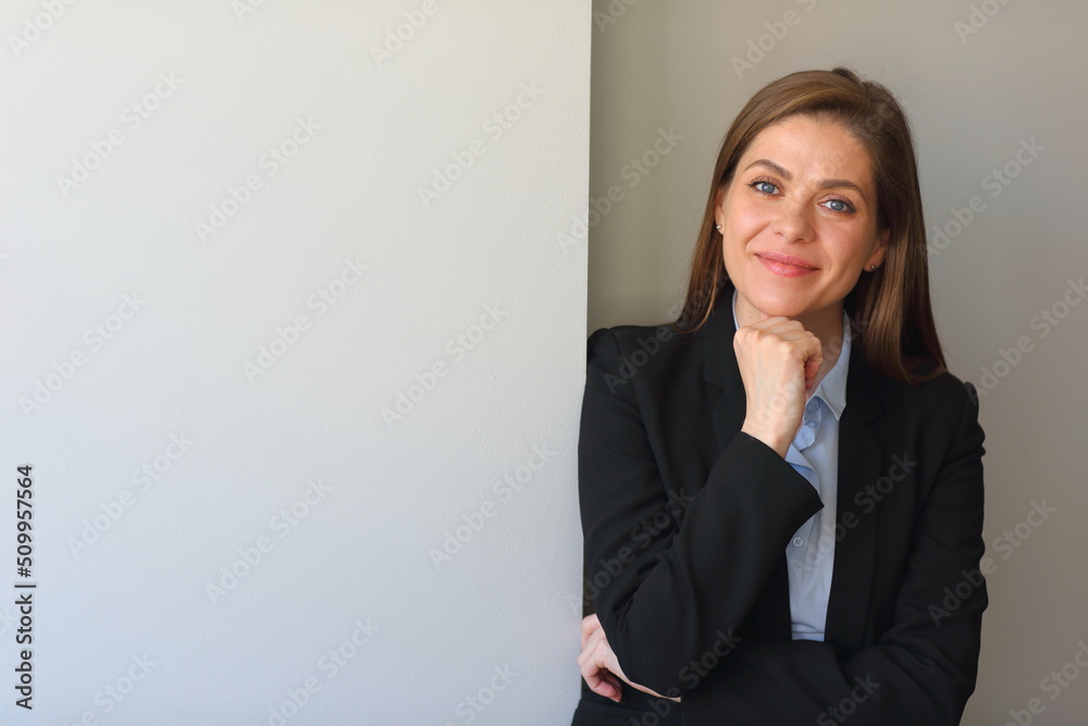 Smiling woman in black business suit touch chin. Smiling woman in black business suit touch chin.