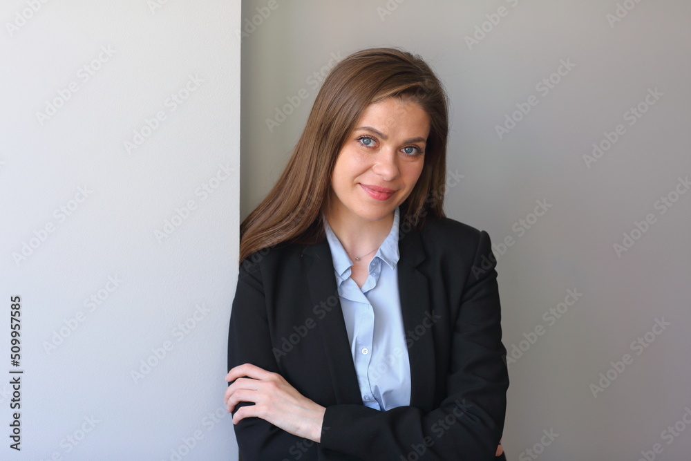 Smiling woman in business suit portrait with crossed arms. Smiling woman in business suit portrait with crossed arms.