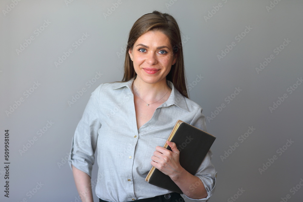 Student woman holding work books. Smiling girl portrait.
