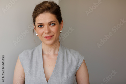 Business woman isolated portrait. smiling woman on gray.