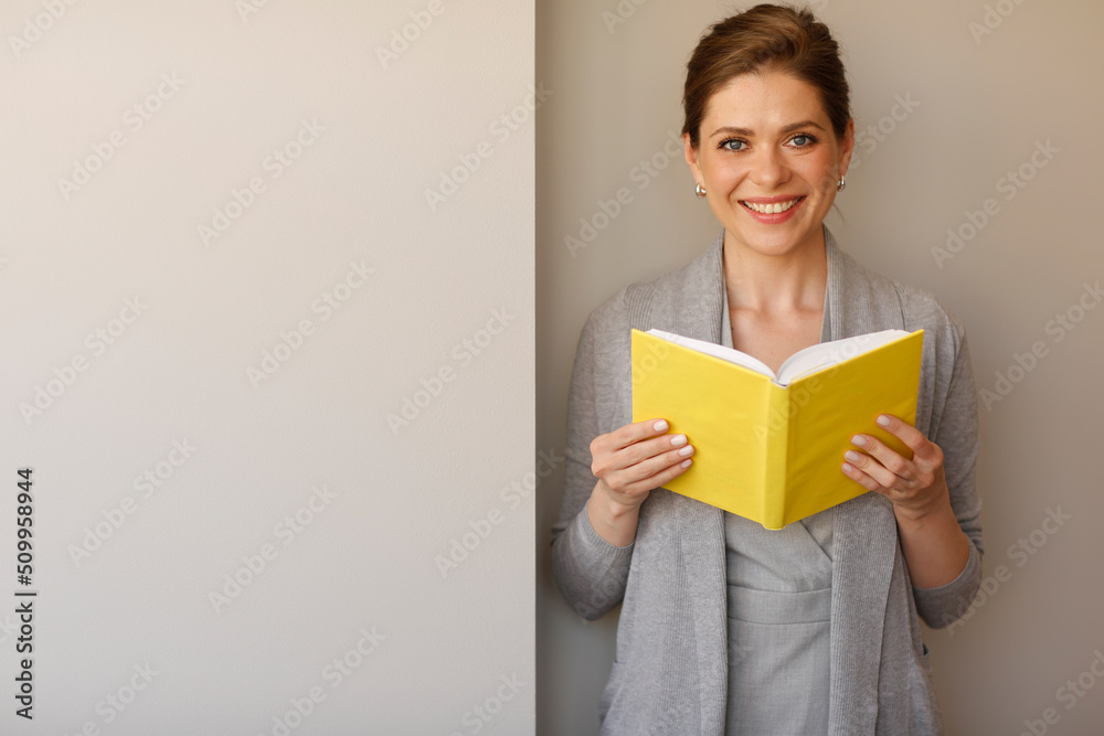 Smiling student girl holding open book. isolated portrait with copy space. Smiling student girl holding open book. isolated portrait with copy space.