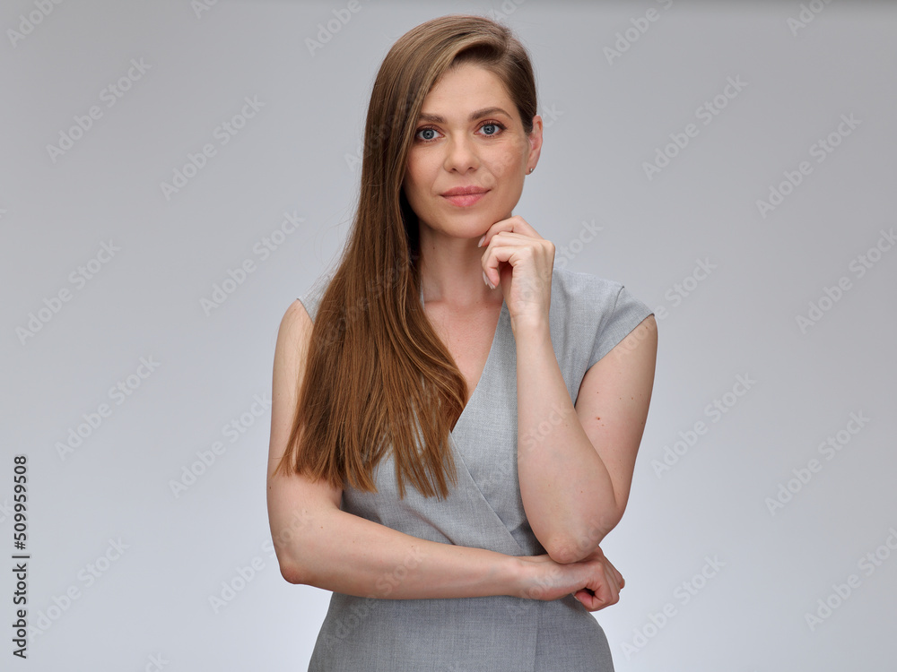 Smiling thinking business woman touching her chin looking at camera, isolated female portrait.