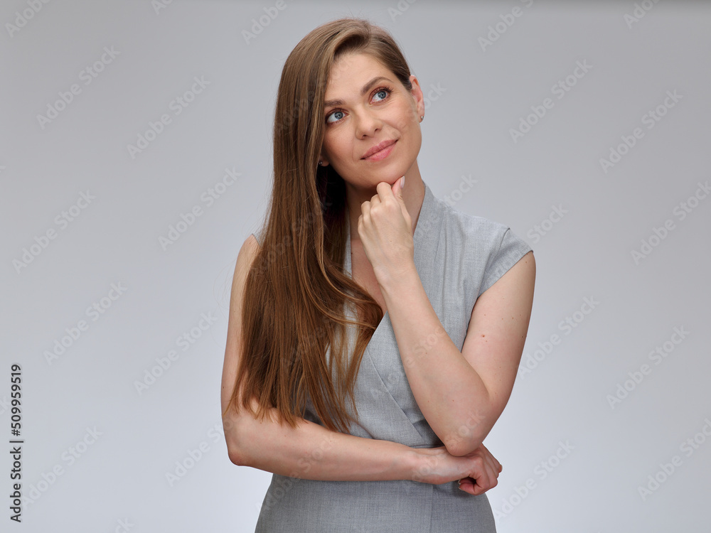 Smiling thinking business woman looking up and touching her chin, isolated female portrait. Smiling thinking business woman looking up and touching her chin, isolated female portrait.