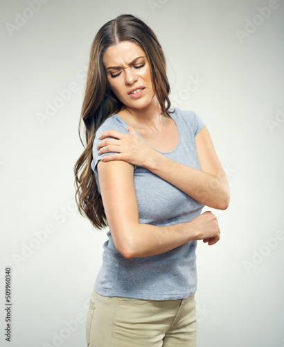 Woman with shoulder pain. Face with pain suffering. Isolated portrait.