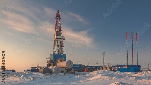 A general view of a drilling rig for drilling wells at an oil and gas field in the Arctic region. Winter. Day. Drilling equipment and technical infrastructure photo