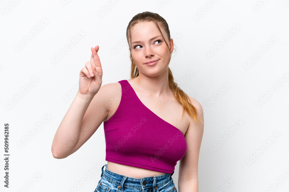 Young caucasian girl isolated on white background with fingers crossing and wishing the best Young caucasian girl isolated on white background with fingers crossing and wishing the best