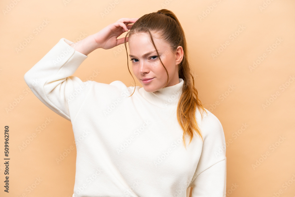 Young caucasian woman isolated on beige background having doubts while scratching head Young caucasian woman isolated on beige background having doubts while scratching head