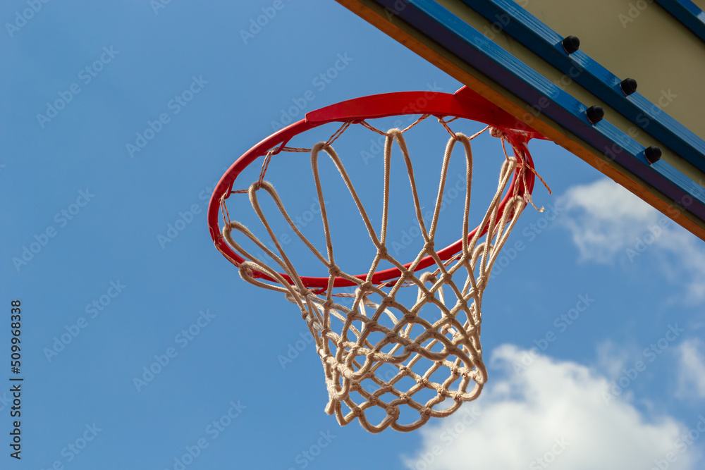 Photo of glass basketball hoop and blue sky background,basketball basket