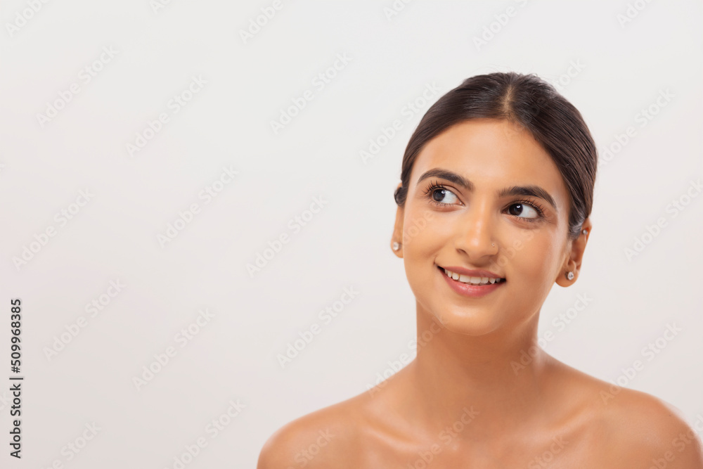 Close-up portrait of a cheerful young woman with clear and spotless skin Close-up portrait of a cheerful young woman with clear and spotless skin