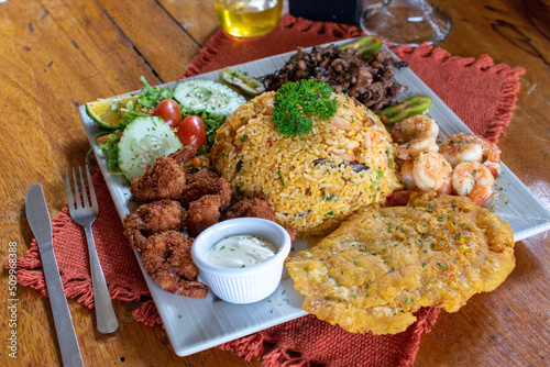Spectacular rice with shrimp and fried breaded shrimp with tostones photo