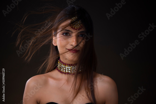 Portrait of a beautiful young woman with beautiful maang tikka and necklace photo