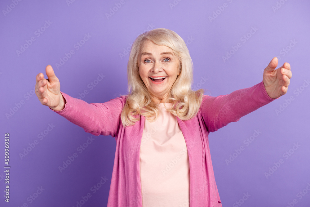 Photo of mature cheerful lady open arms welcome meeting grandchild isolated over purple color background Photo of mature cheerful lady open arms welcome meeting grandchild isolated over purple color background