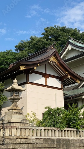 The rooftop decor and stone lantern of ancient Japanese shrine house, Ueno park "Gojyoten Jinjya” temple, year 2022 sunny weekday 