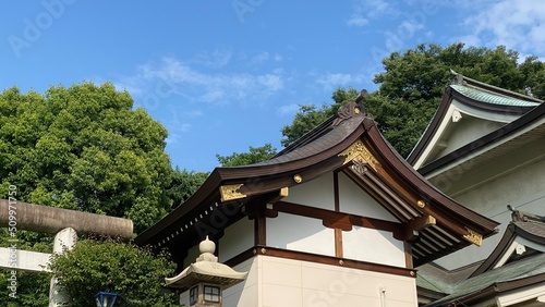 The rooftop decor and stone lantern of ancient Japanese shrine house, Ueno park "Gojyoten Jinjya” temple, year 2022 sunny weekday 