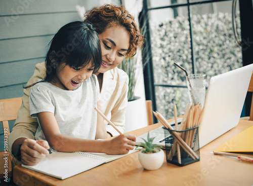 Family time, mom and girl enjoy learning on internet, helping kid study from home, work from home, having breakfast   photo