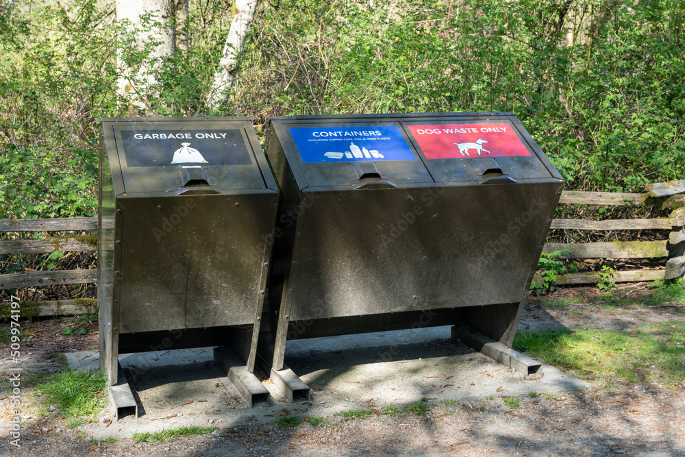 Garbage bin for garbage only and containers and dog waste only. Trash container in public park. Garbage bin for garbage only and containers and dog waste only. Trash container in public park.