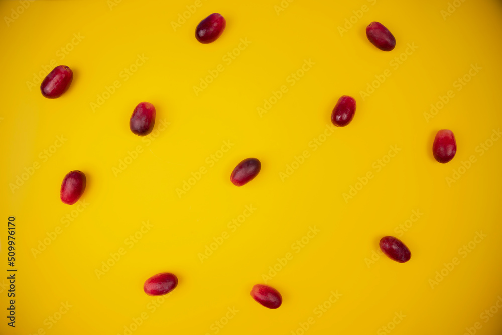 group of fresh and tender red grapes on a pastel yellow background group of fresh and tender red grapes on a pastel yellow background