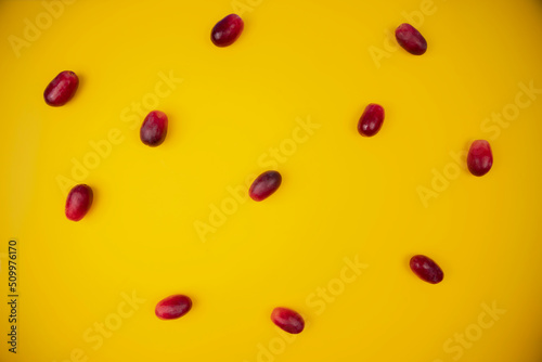 group of fresh and tender red grapes on a pastel yellow background