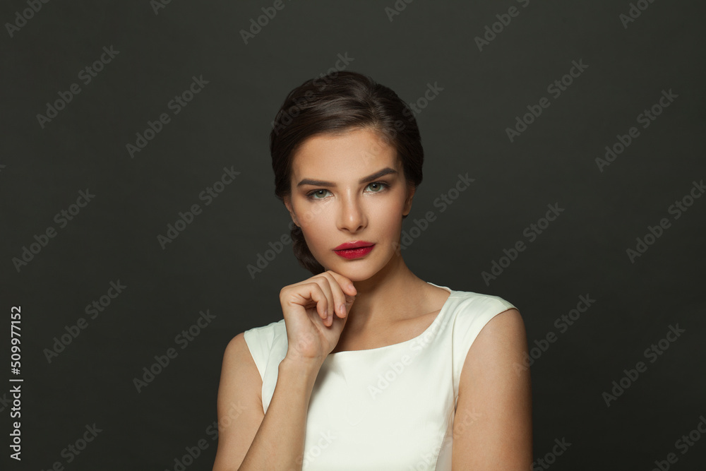 Glamourous brunette woman model with fresh makeup, red lips and dark eyebrows Glamourous brunette woman model with fresh makeup, red lips and dark eyebrows