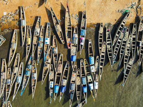 Aerial view of traditional fishing boat in a small harbour on the beach along the coast near Freetown, Sierra Leone.