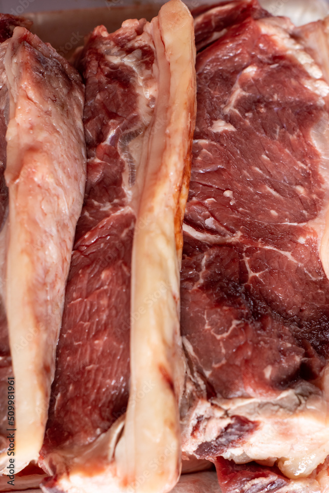 Fototapeta premium vertical close up of a tray of raw ribeye meat prepared for cooking