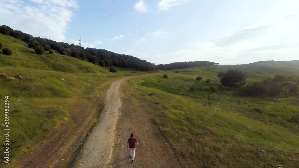 aerial man walking in nature aerial man walking in nature
