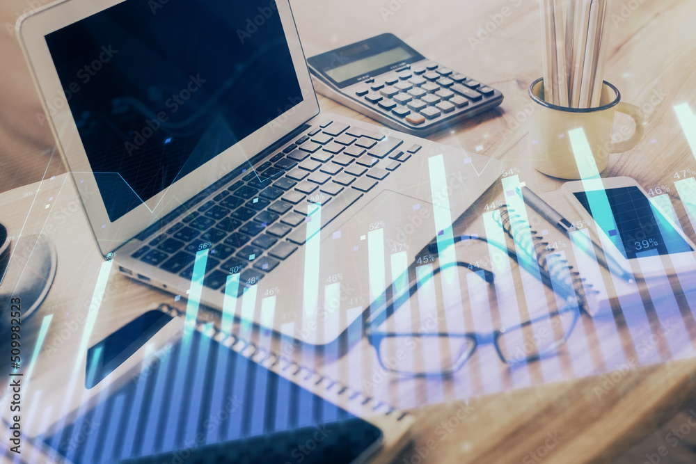 Forex market chart hologram and personal computer background. Multi exposure. Concept of investment. Forex market chart hologram and personal computer background. Multi exposure. Concept of investment.