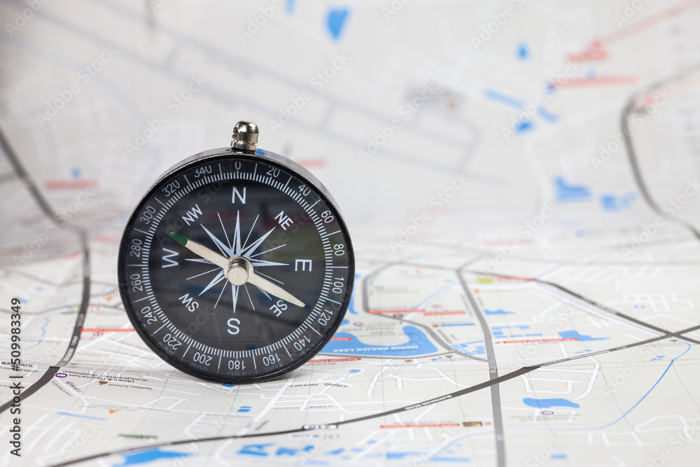 Compass on the map background of blur. Compass on the map background of blur.