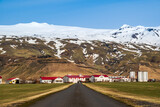 Road leading towards Thorvaldseyri farm, the famous farmstead located right in front of Eyjafjallajökull glacier and volcano with its snow-capped summit, Route 1 / Ring Road, Southern Region, Iceland