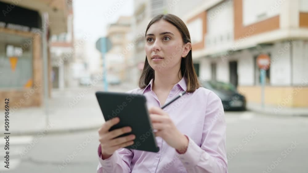 Young hispanic woman using touchpad at street Young hispanic woman using touchpad at street