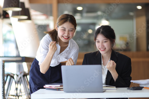 Businesswoman and office colleagues express excitement and happiness as the job is accomplished and the bonus is awarded.