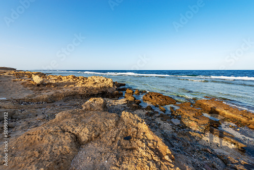 Beautiful seascape of Red Sea near Marsa Alam, Egypt, Africa. The waves breaking on the coral reef and the cliff.