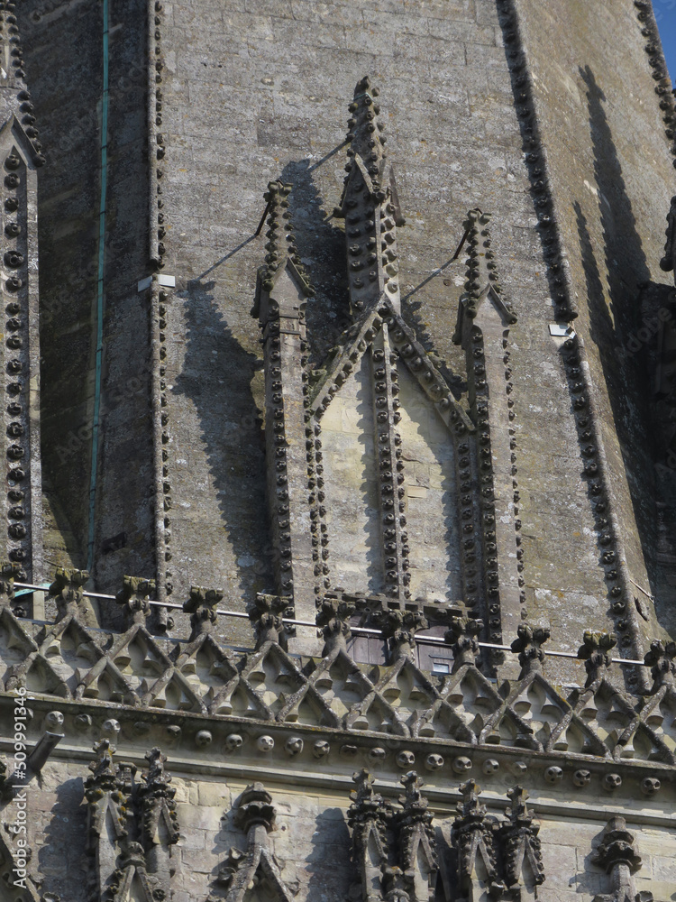 Gothic Cathedral of Salisbury. 13-14 century. Top detail decoration with walled up dormer and pinnacles in the bell tower.
England. United Kingdom.