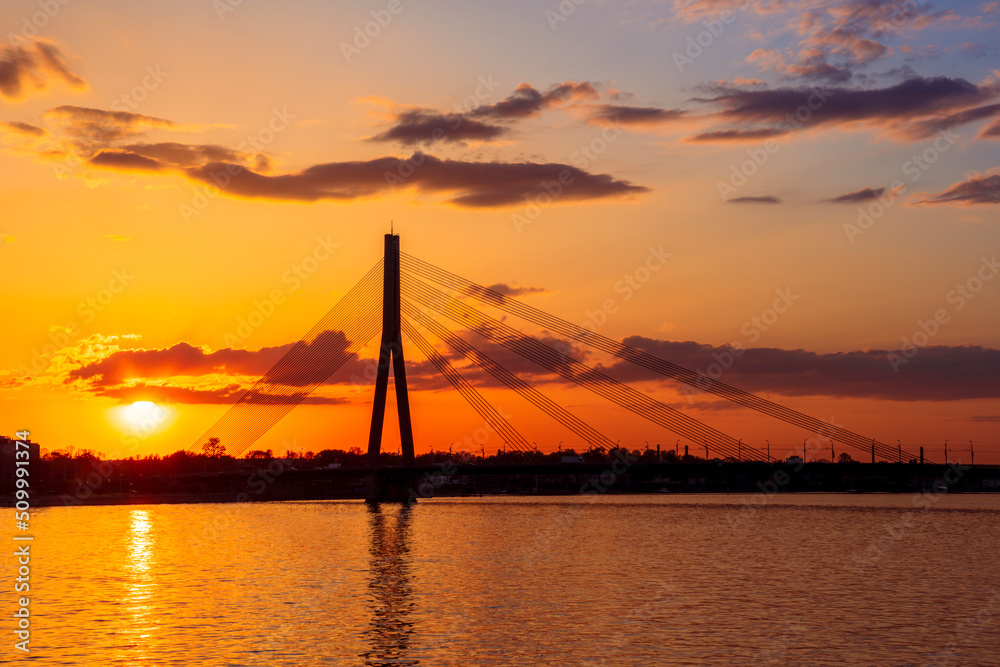 Obraz premium picturecque view from water surface to large river and cable - stayed bridge